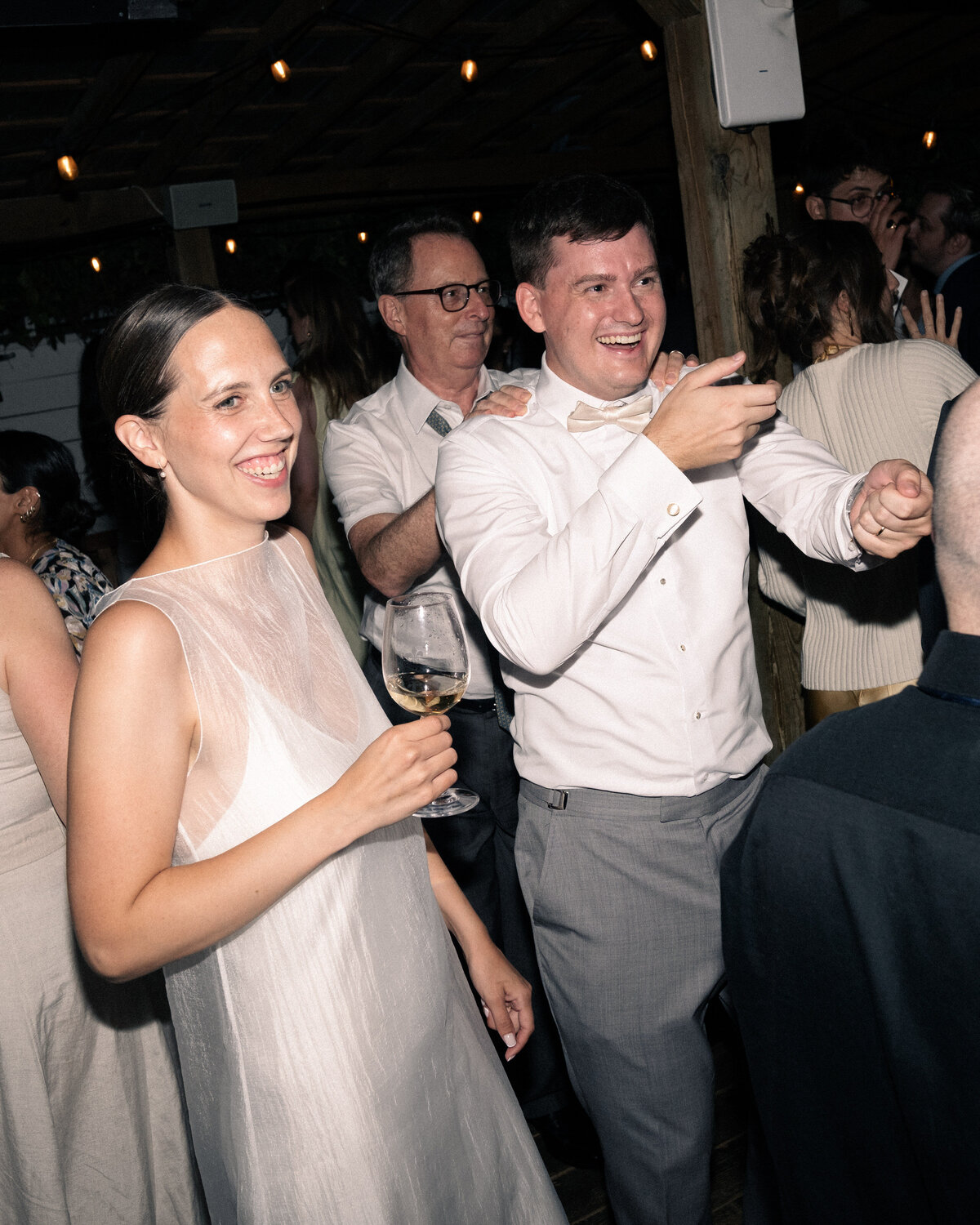 late-night dancing with the bride and groom trying to bring more people in