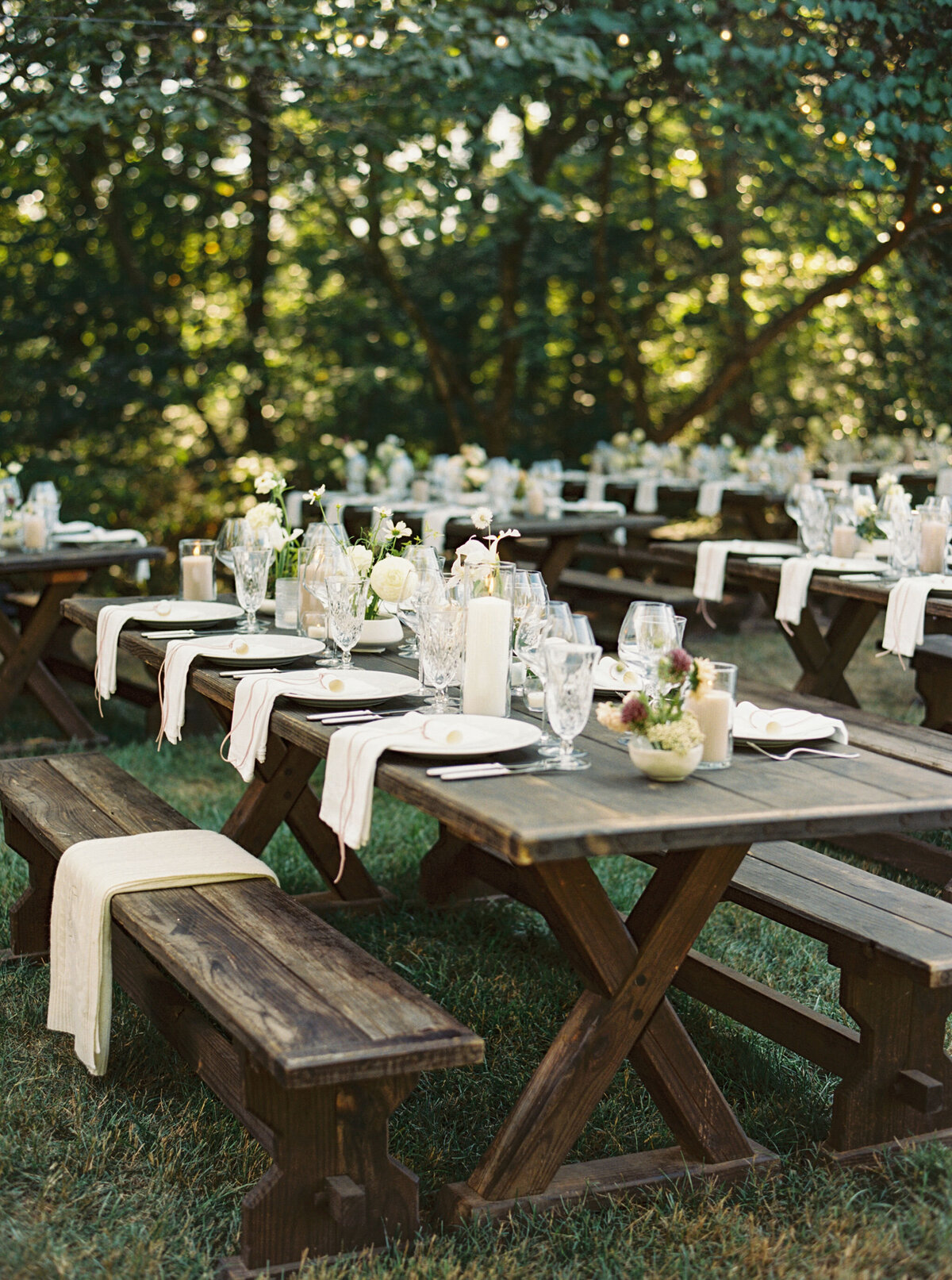 Fall wedding at Blackberry Farm. Welcome party for wedding guests at Yallerhammer Pavilion on property at Blackberry Farm. Growing floral installation with whimsical florals for entrance to reception. Rustic and earthy floral design with elegant notes of blush and cream. Wildflower design in ikebana style with glowing candlelight reception tables. Destination wedding at Blackberry Farm. Design by Rosemary & Finch Floral Design in Nashville, TN.
