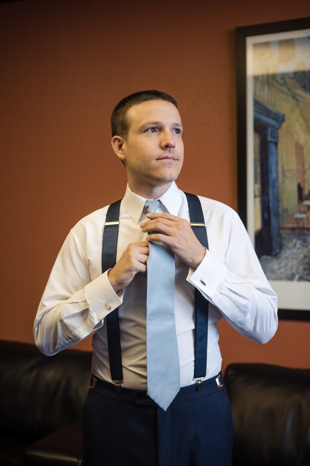 groom-getting-ready-tie-suspender-jps-events.jpg