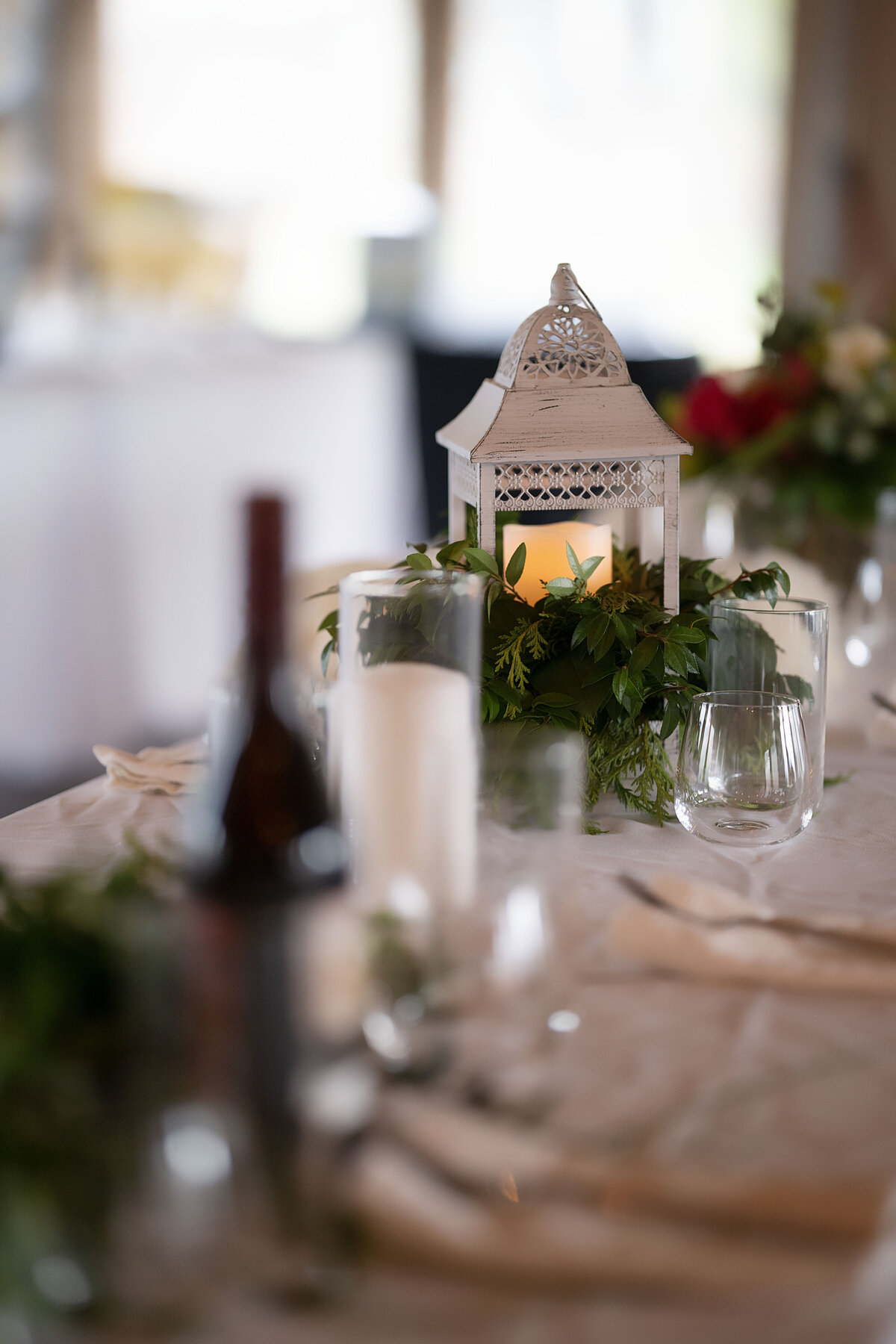 A table is set at an Aspen, Colorado wedding with beautiful lighting and luxury wines,