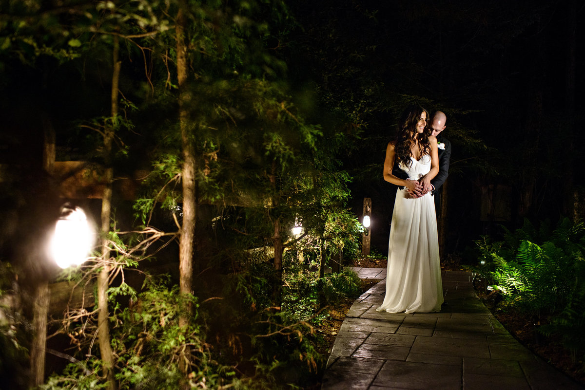 A bride and groom holding each other right outside of their reception at Holly Hedge Estate.