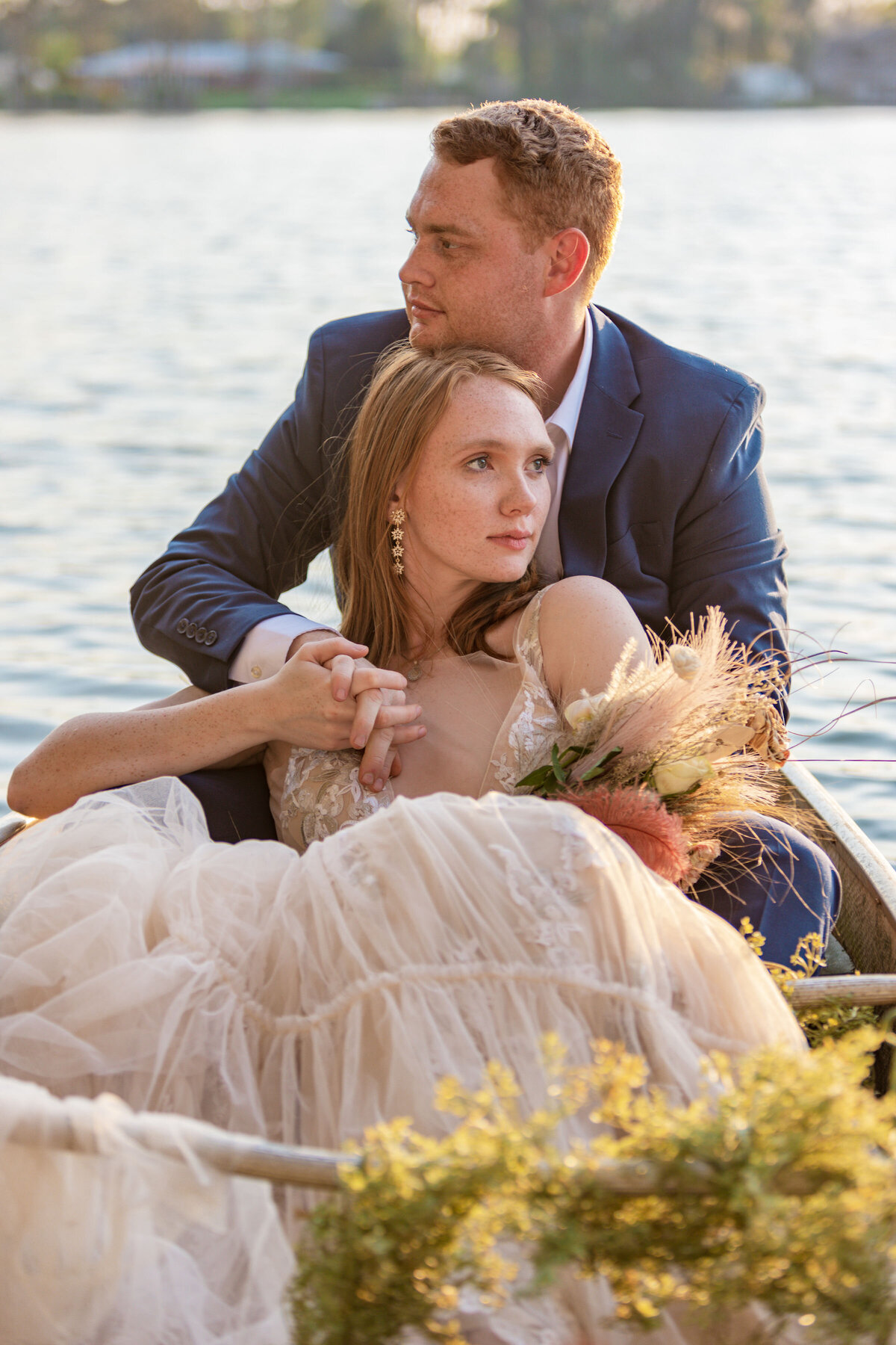 Bride and groom posing in the boat. 