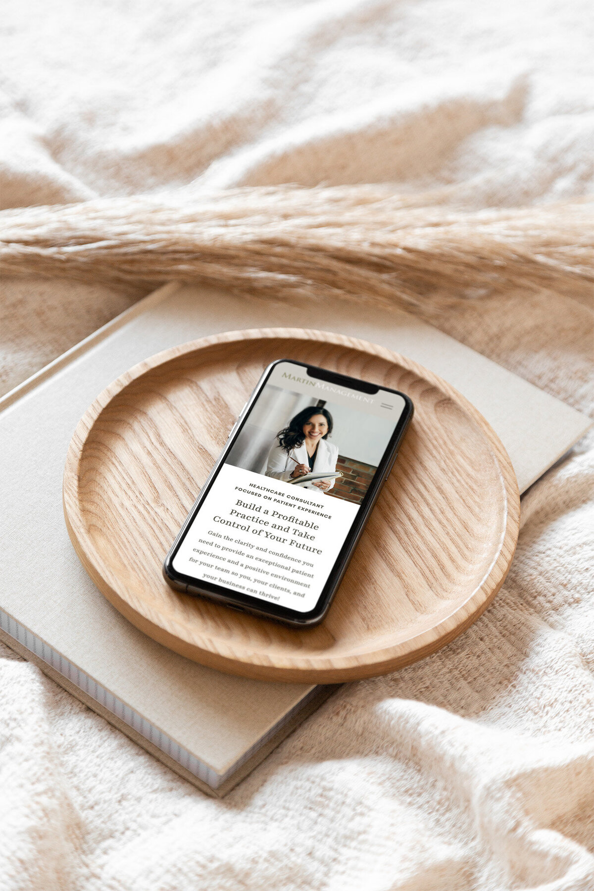 Iphone with medical consultant website sitting on wood tray