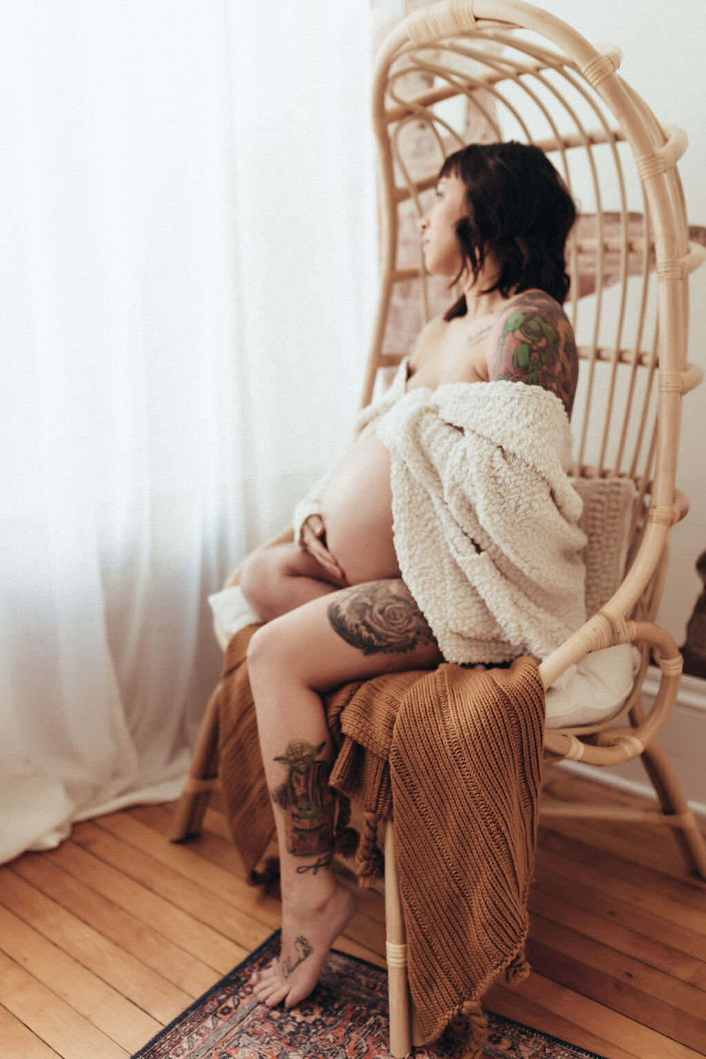 pregnant woman sitting in chair by window