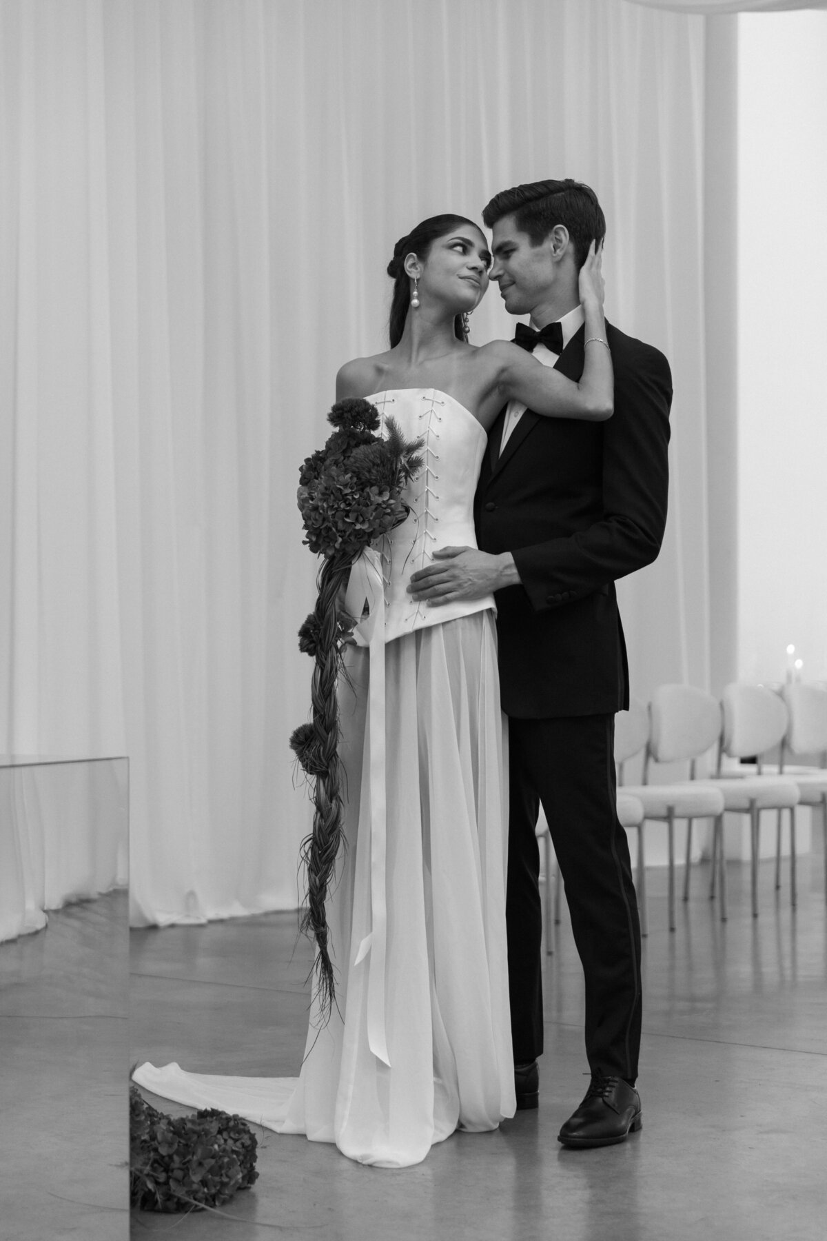 Bride laughing with groom during a candid moment at a modern New York City editorial wedding shoot.