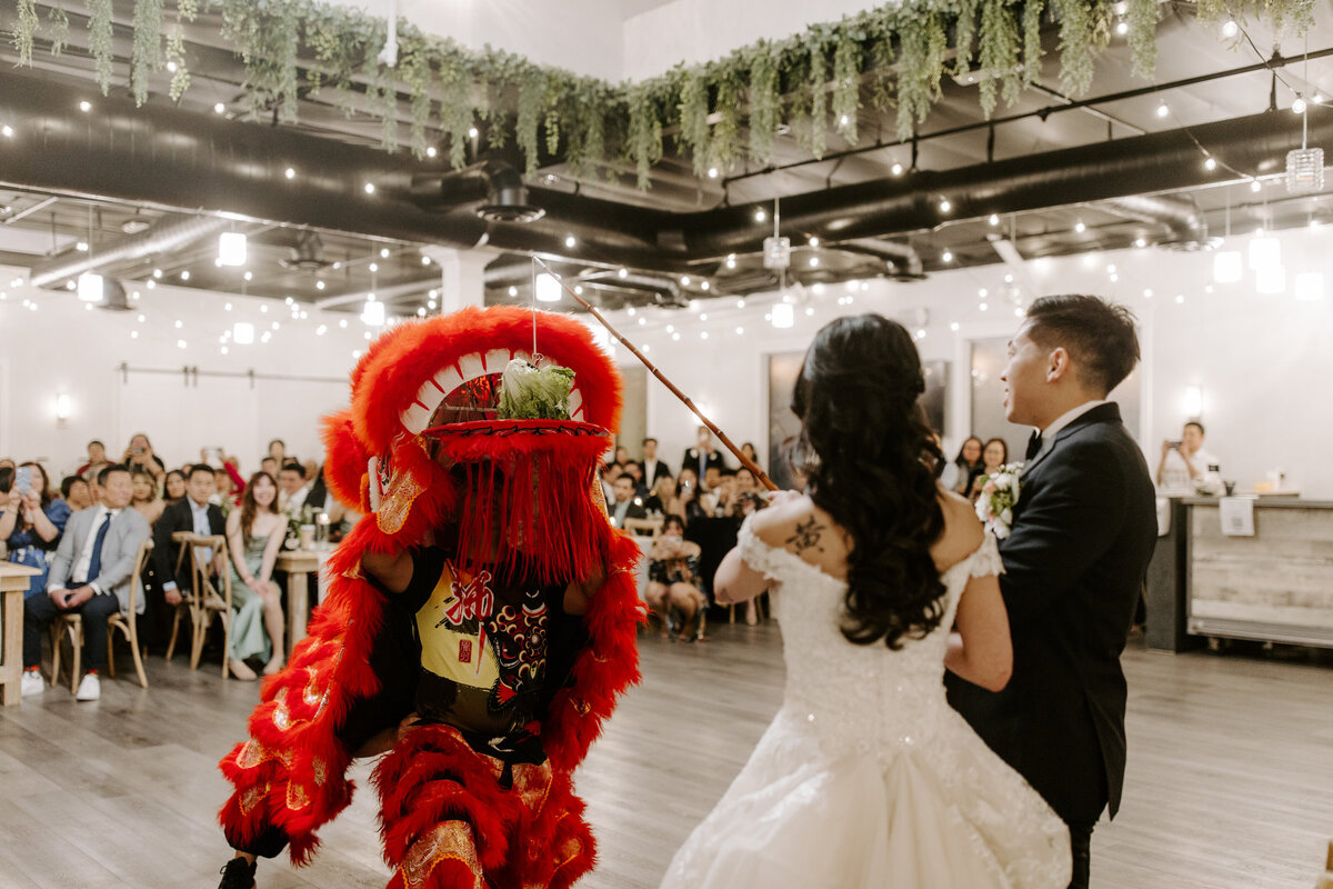 A bride watches a performance on her wedding day.