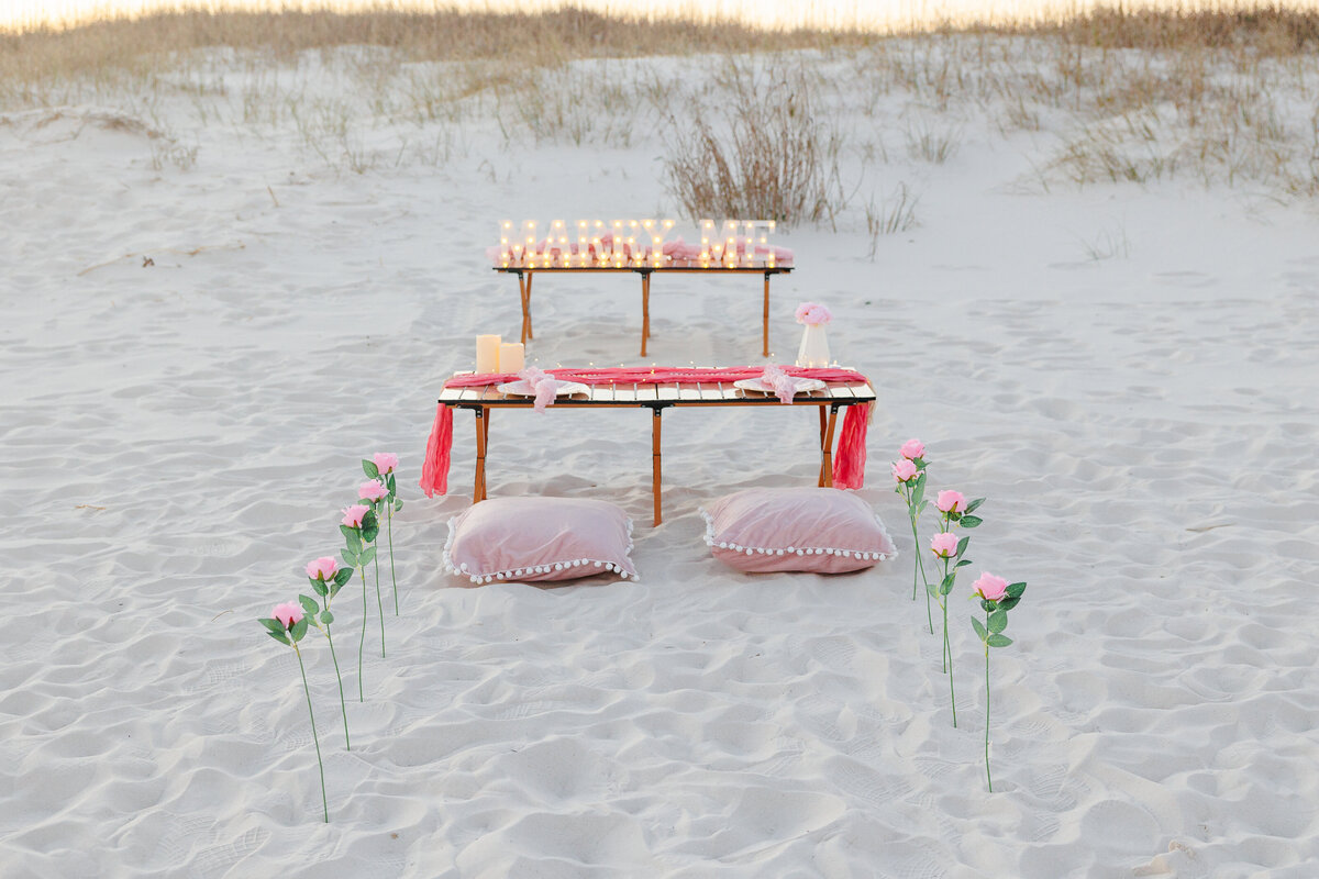 Light up marry me sign with table roses and pillows