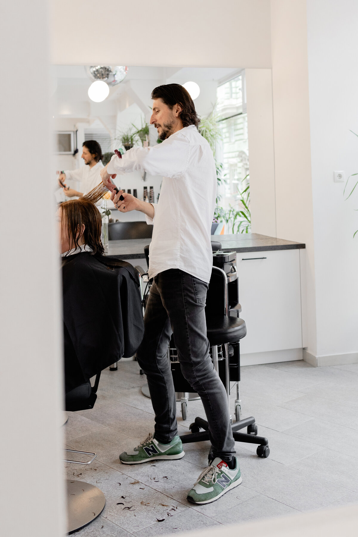 Hair stylist styling a woman's hair