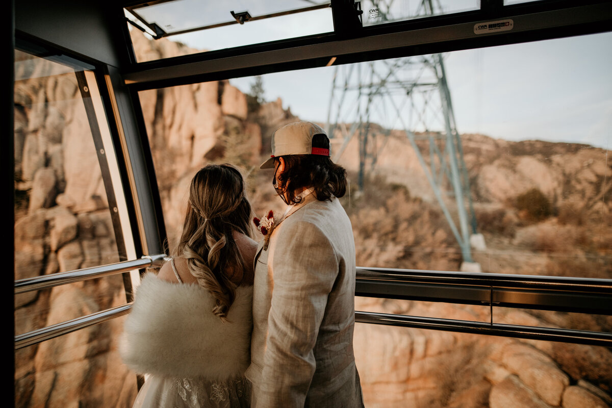 Bride and Groom Riding Sandia Peak Tram after mountain top elopement