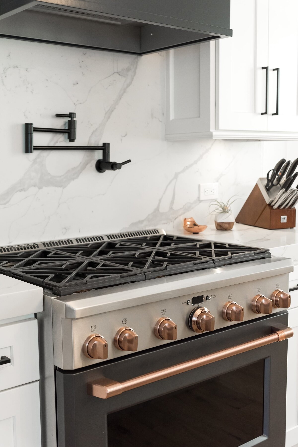 dewine design orlando interior designer modern lakehouse kitchen oven with copper nobs and black pot filler