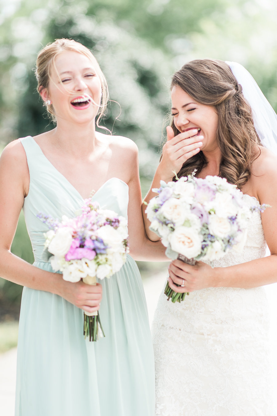 Bride and her maid of honor laughing at Morias Vineyard.