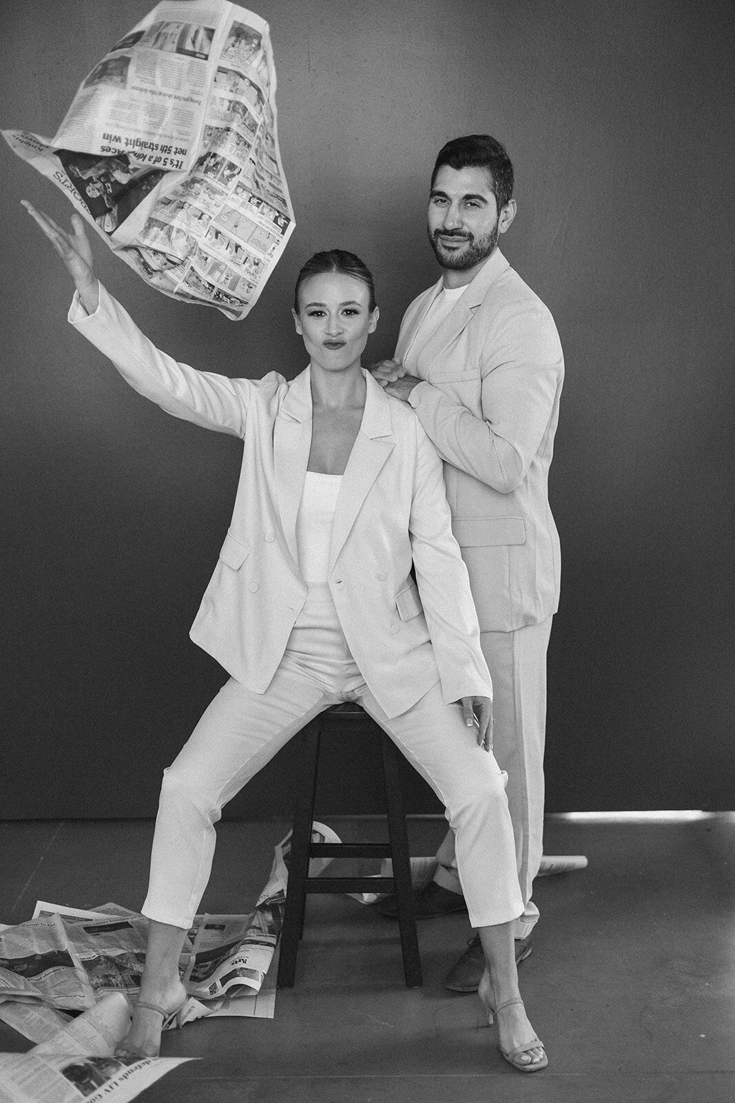 A couple throws newspapers