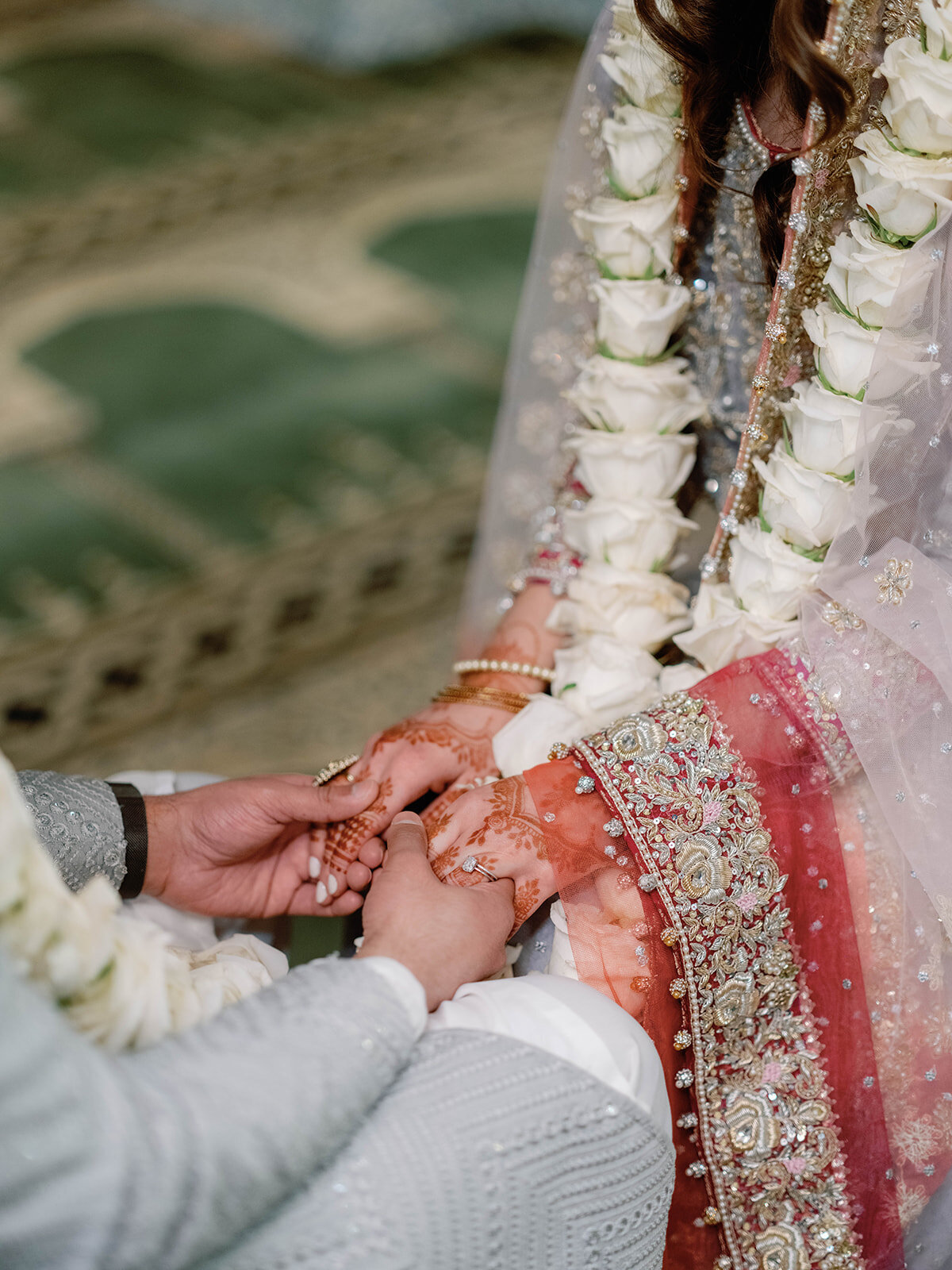 Islamic couple holds hands at their ceremony
