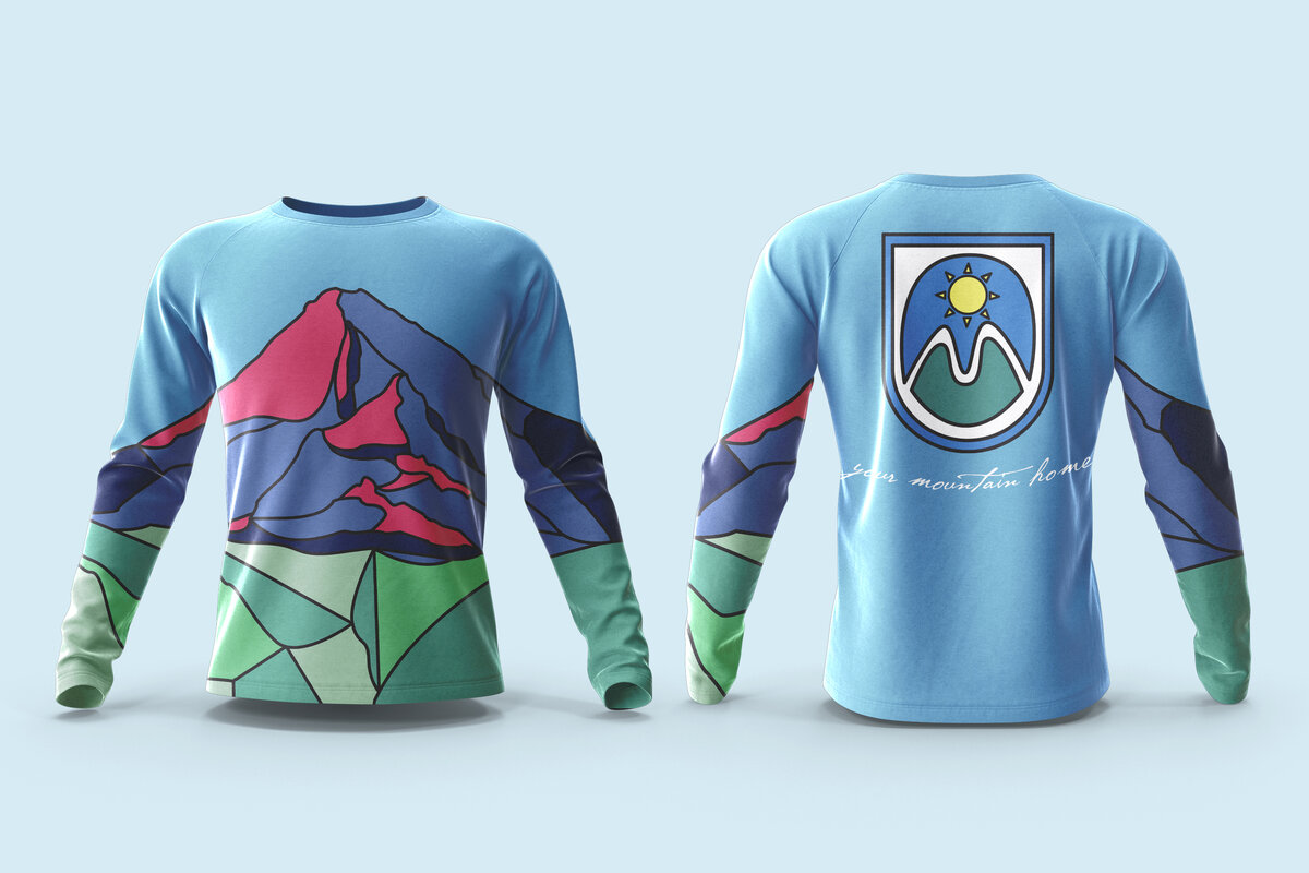 A long sleeve shirt with the design by Ayanna Richilano Designs in color with the stained glass style Mt.Hood artwork created by Ayanna Richilano Designs promoting the suits 'n boots event at Mt.Hood Meadows