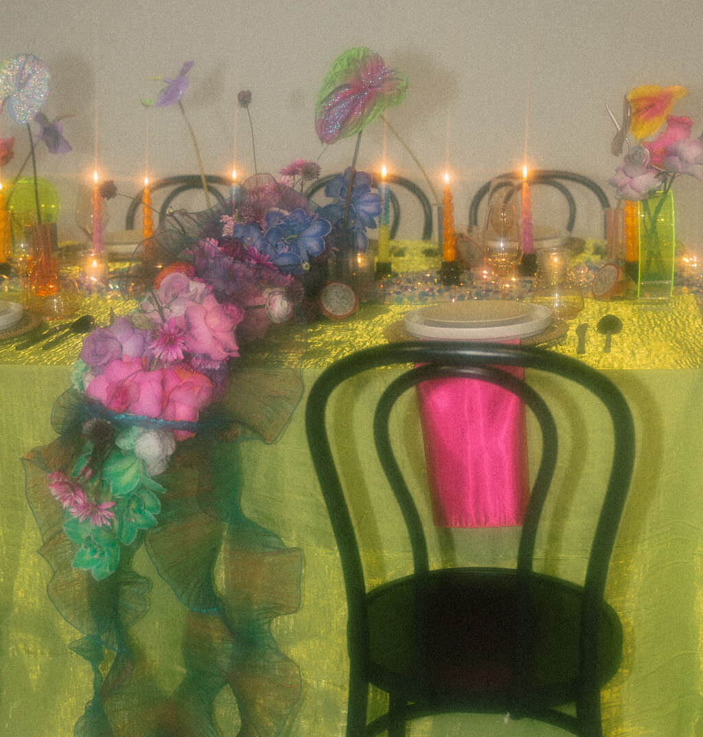 A chair sitting in front of a brightly decorated reception table.