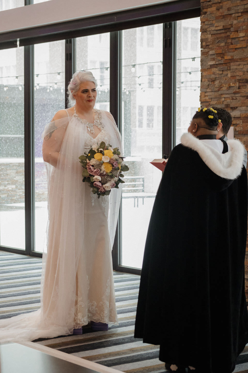 A couple standing up and saying their vows.