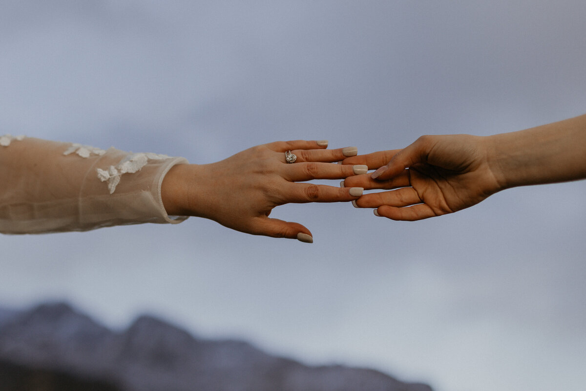 two brides hands holding each other