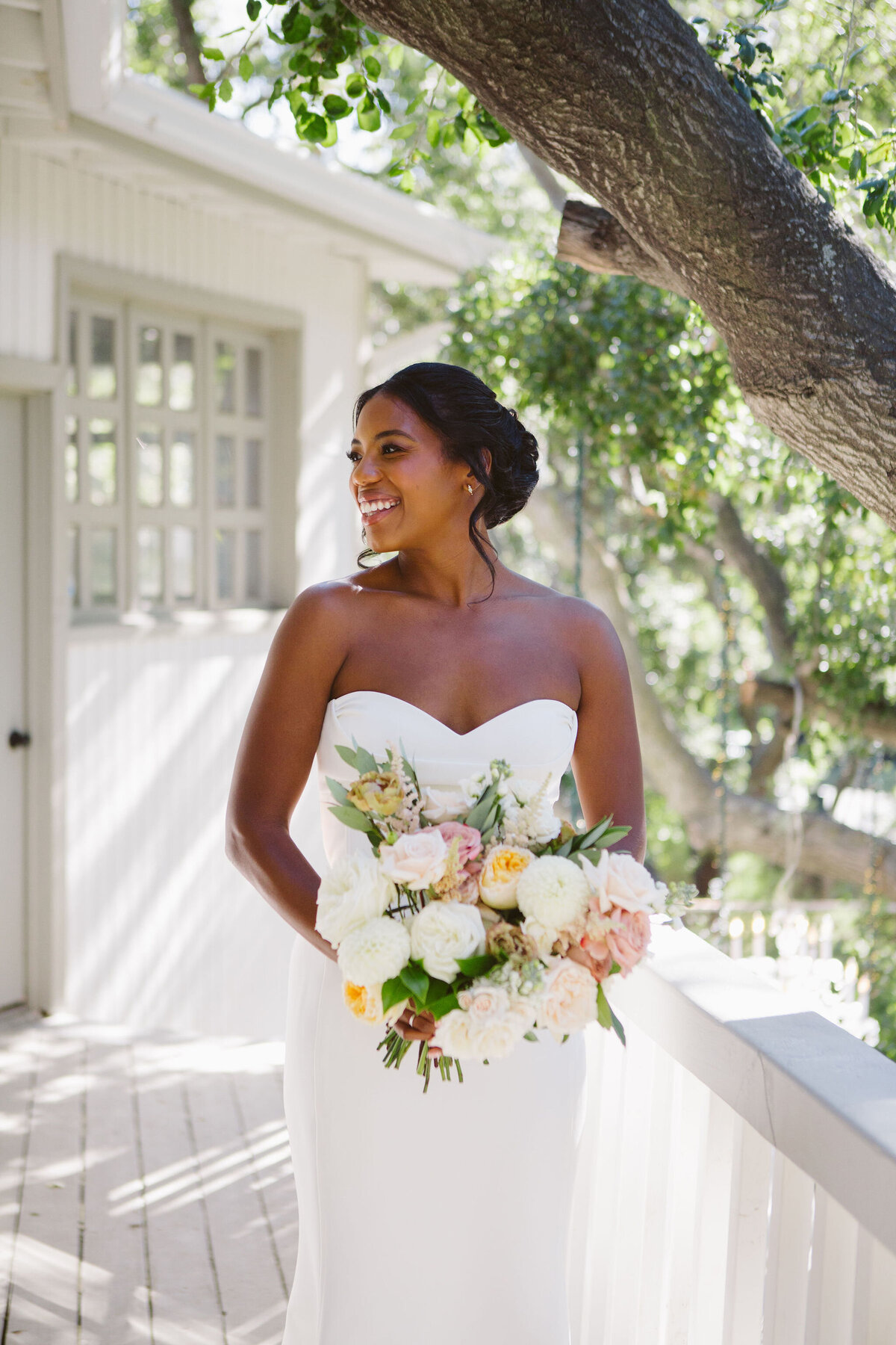 Bride at Calamigos Ranch with white and peach bouquet