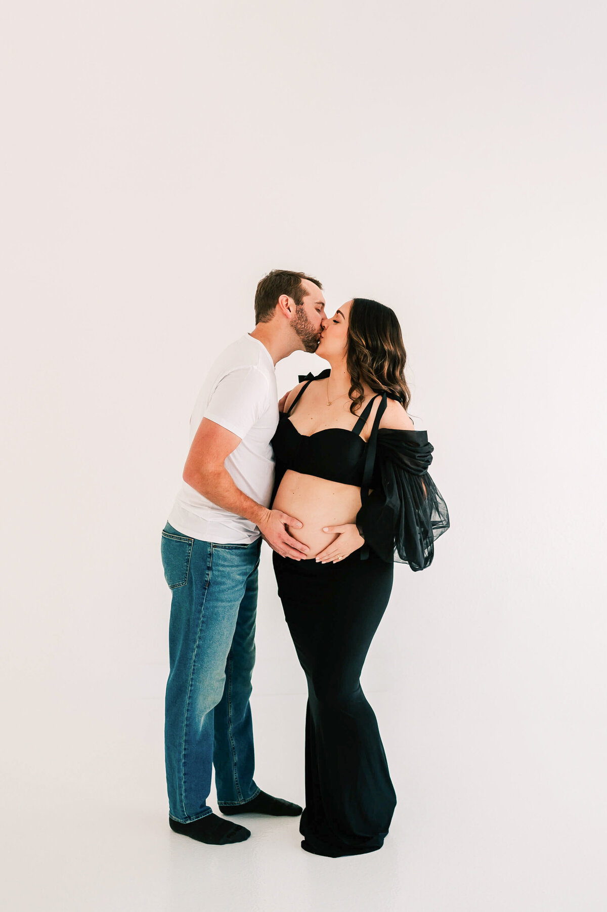 pregnant couple in black and white kissing during Springfield MO maternity photography session