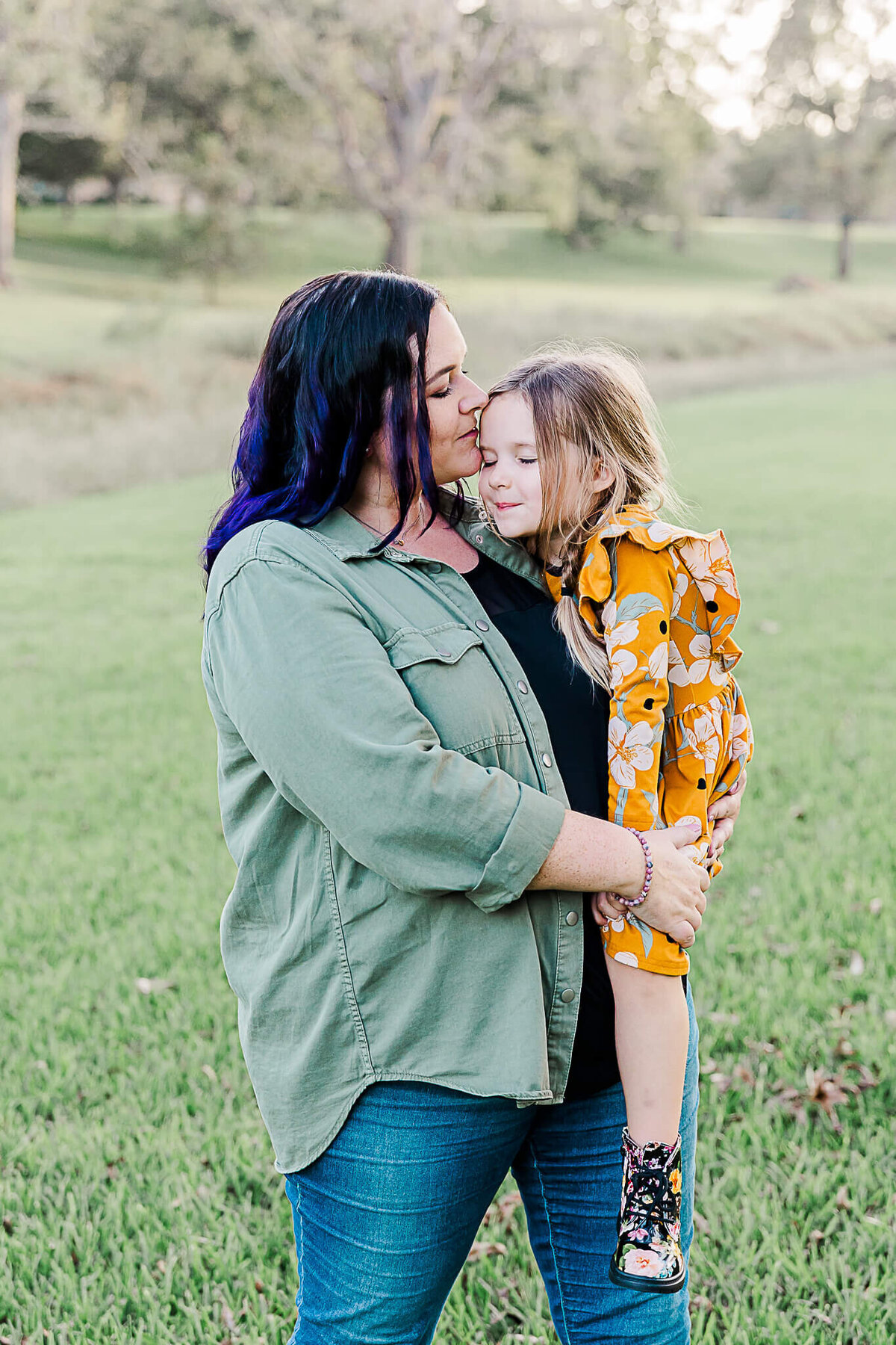 Mom kissing daughter on the head