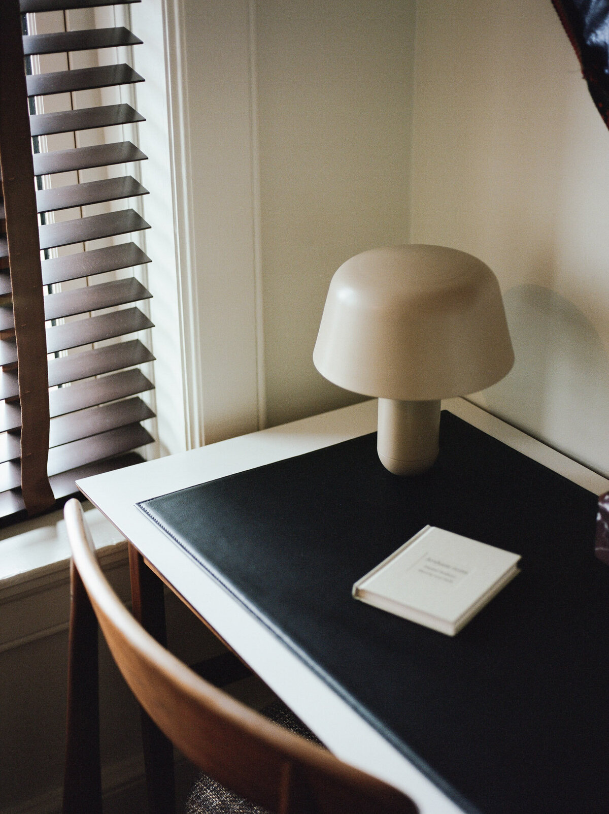 clean desk with black pad, modern lamp, book at ALEO Detroit bed and breakfast