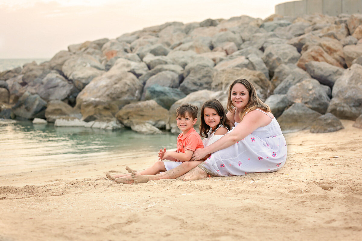 mom-hugging-kids-on-the-beach