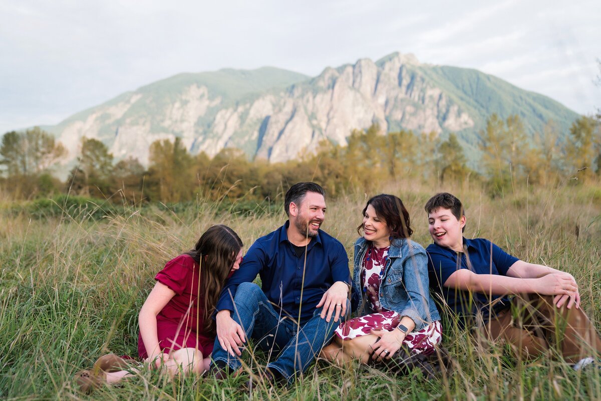 Family laughing together with Mount Si in the background