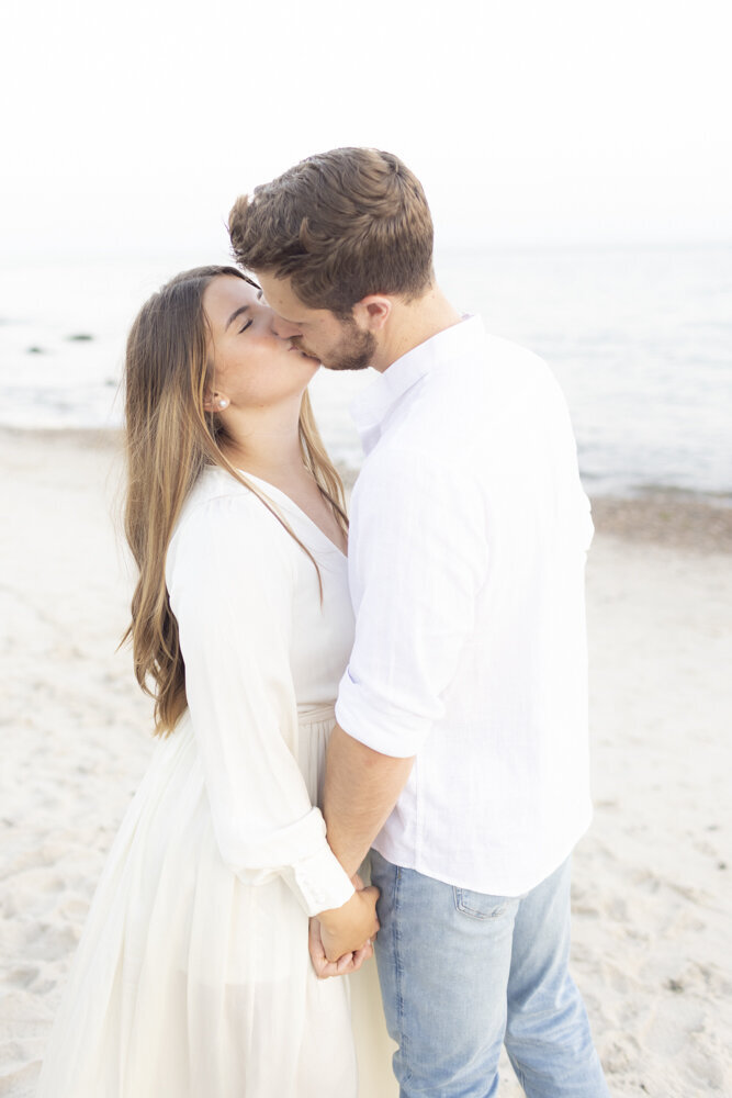 kissing photo of newly engaged couple