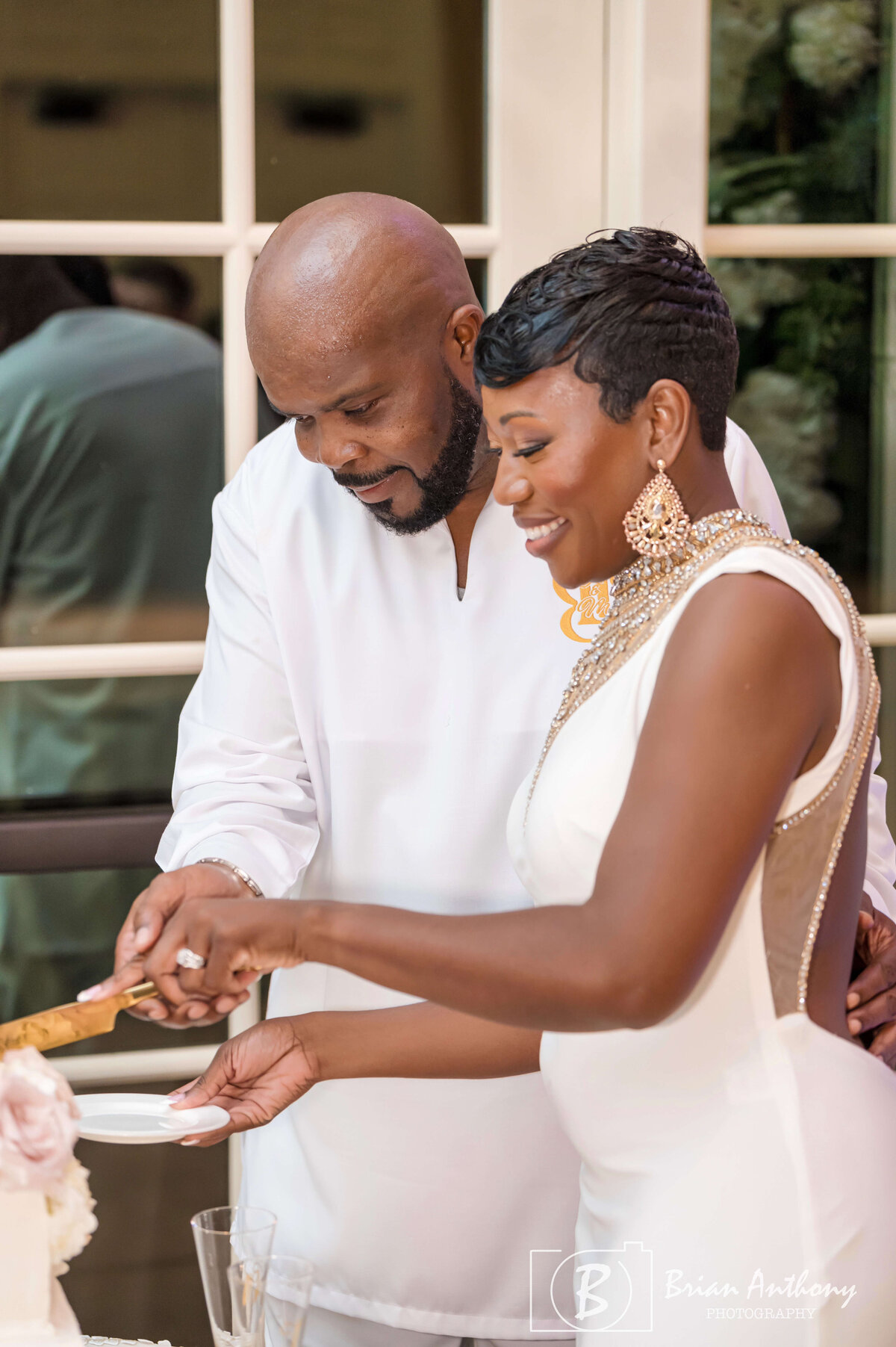 Newlyweds cutting their wedding cake during the reception