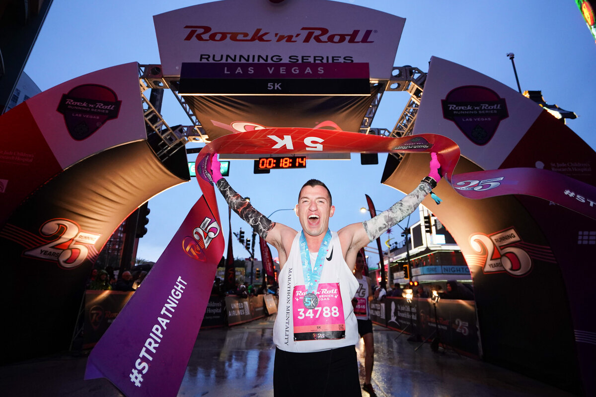 kansas-city-sports-photography-0124-marathon-winner-holding-medal