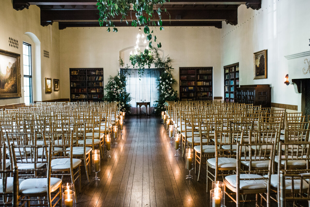 wedding ceremony with candles greenery and flowers