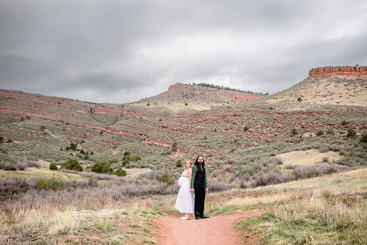 maternity portrait in lyons, colorado featuring pregnant woman in white
