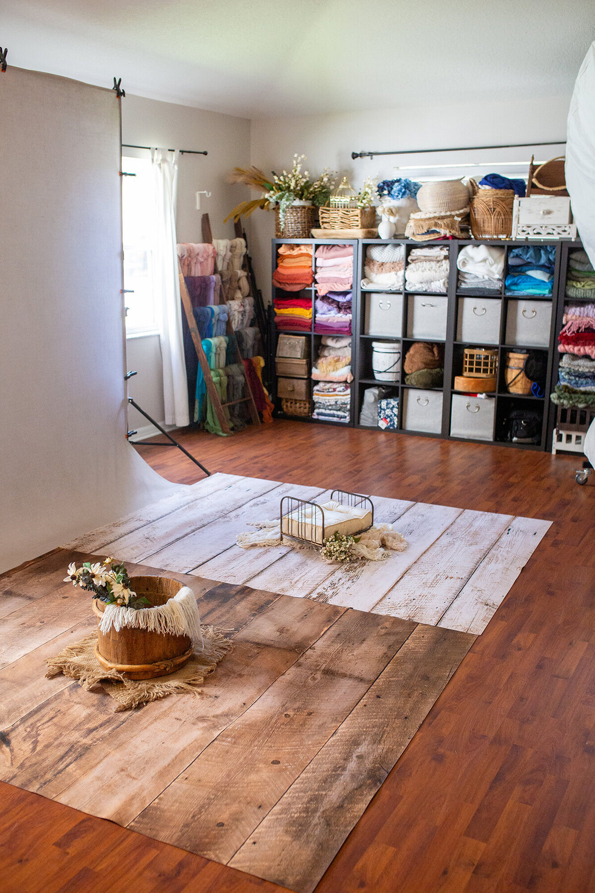A look inside the studio showing beautiful neutral setups, posing wraps, bowls, beds and backgrounds