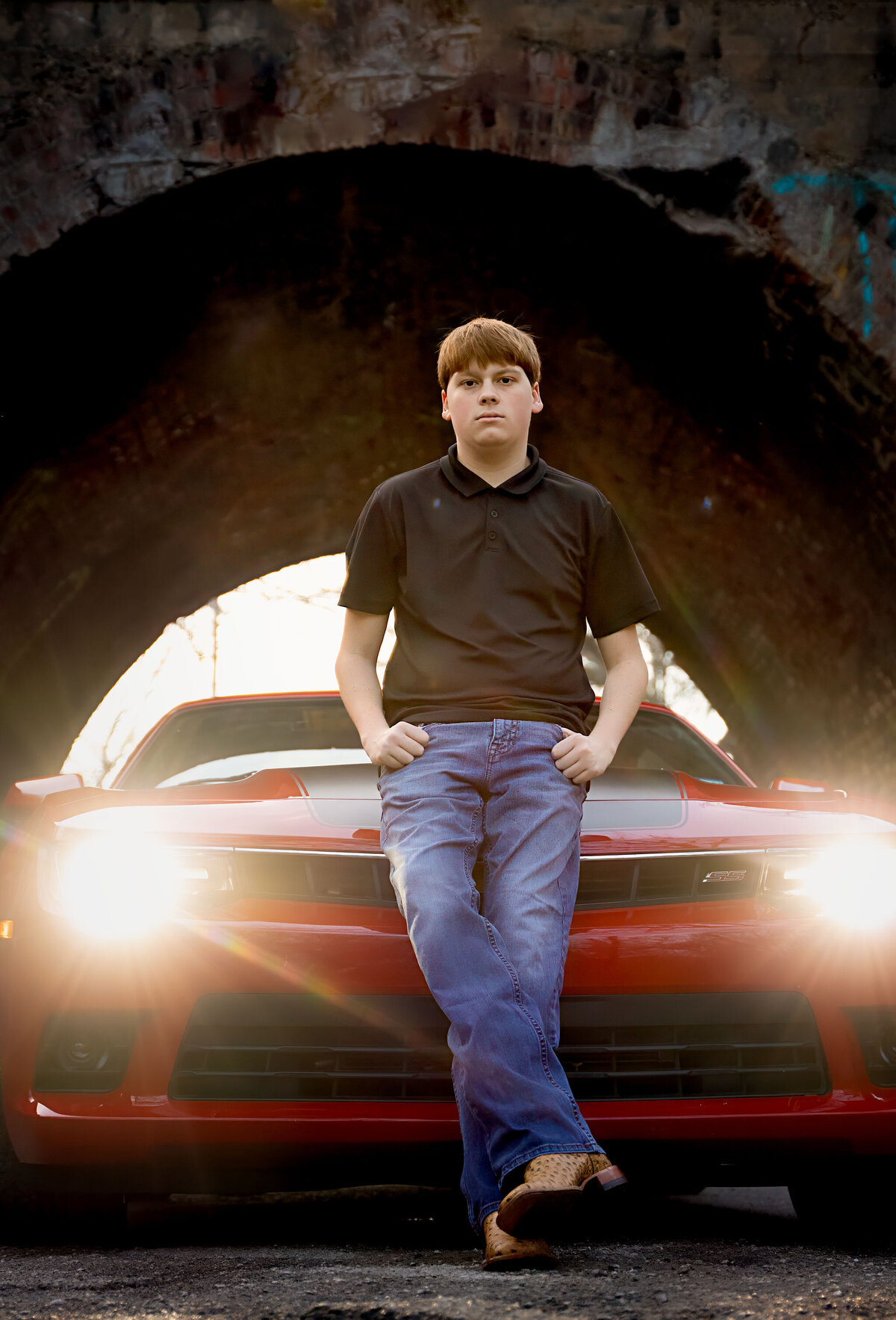 senior in front of cool car