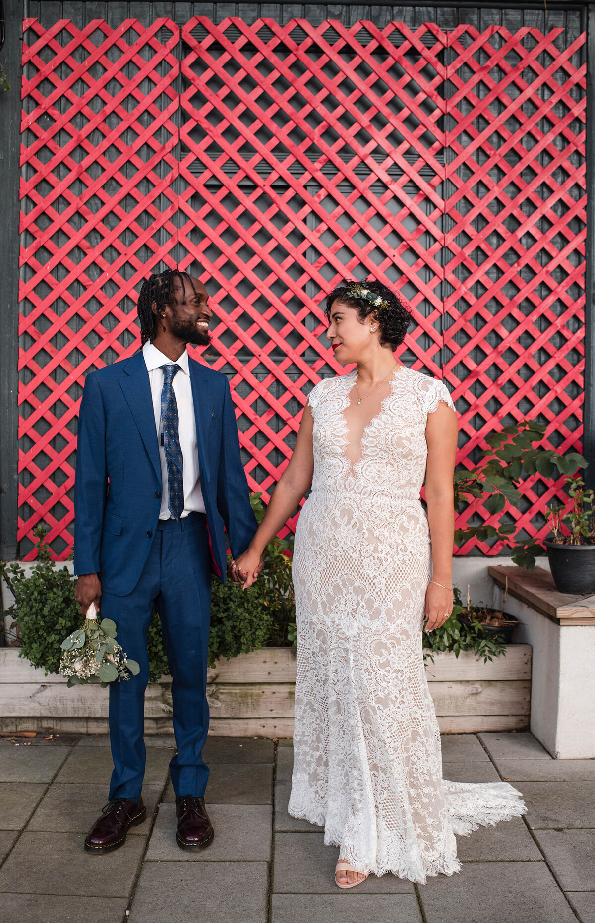 wedding-couple-holding-hands-looking-at-each-other