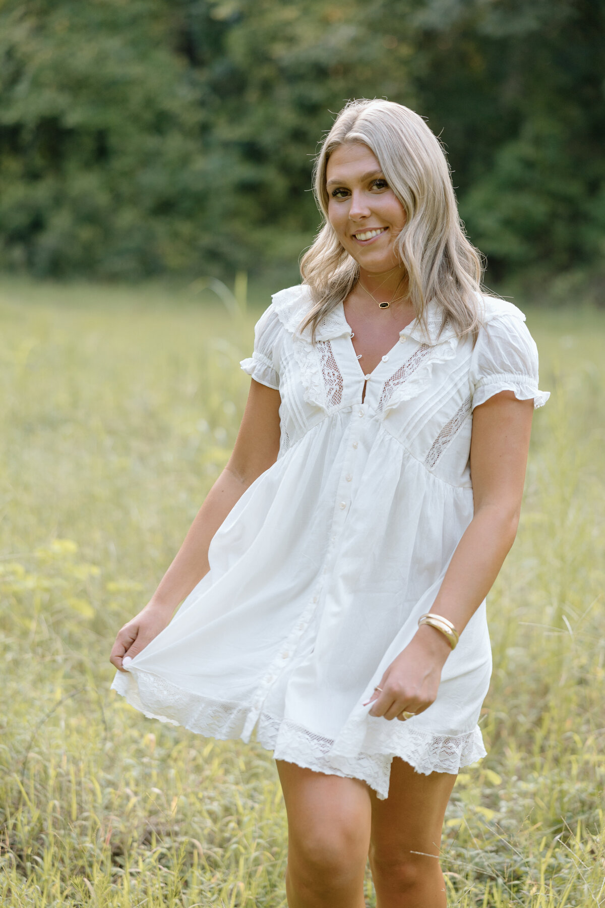 Senior photos in field of tall grass