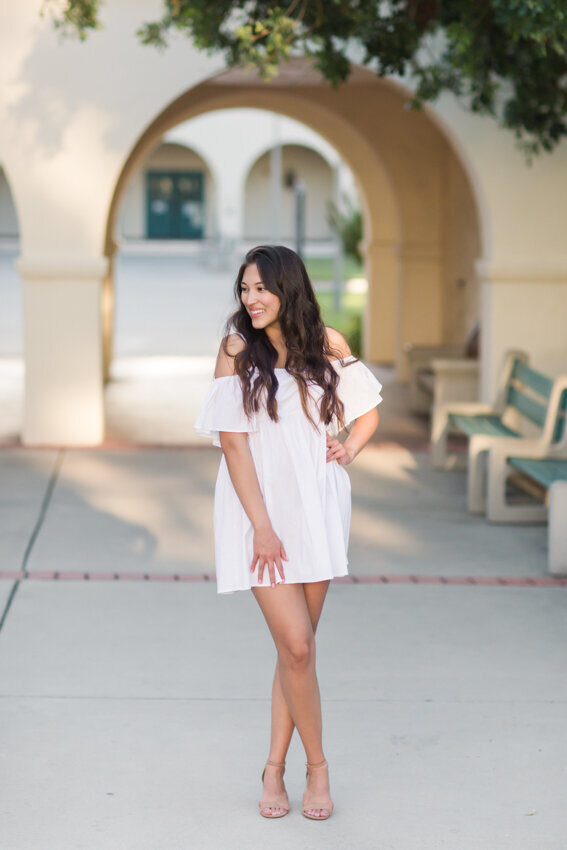 San Diego State senior standing under arch