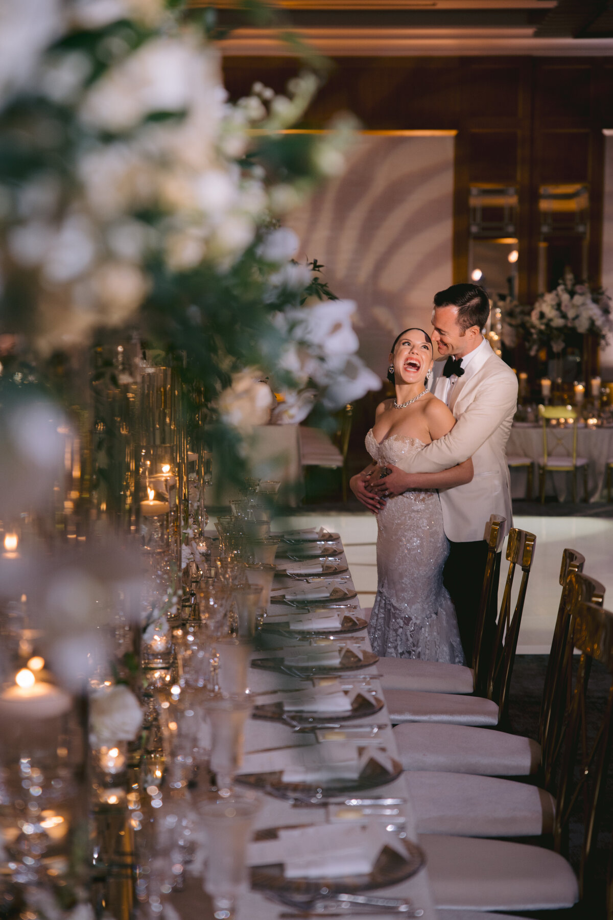 Bride and groom share a joyful moment at their Miami wedding reception.