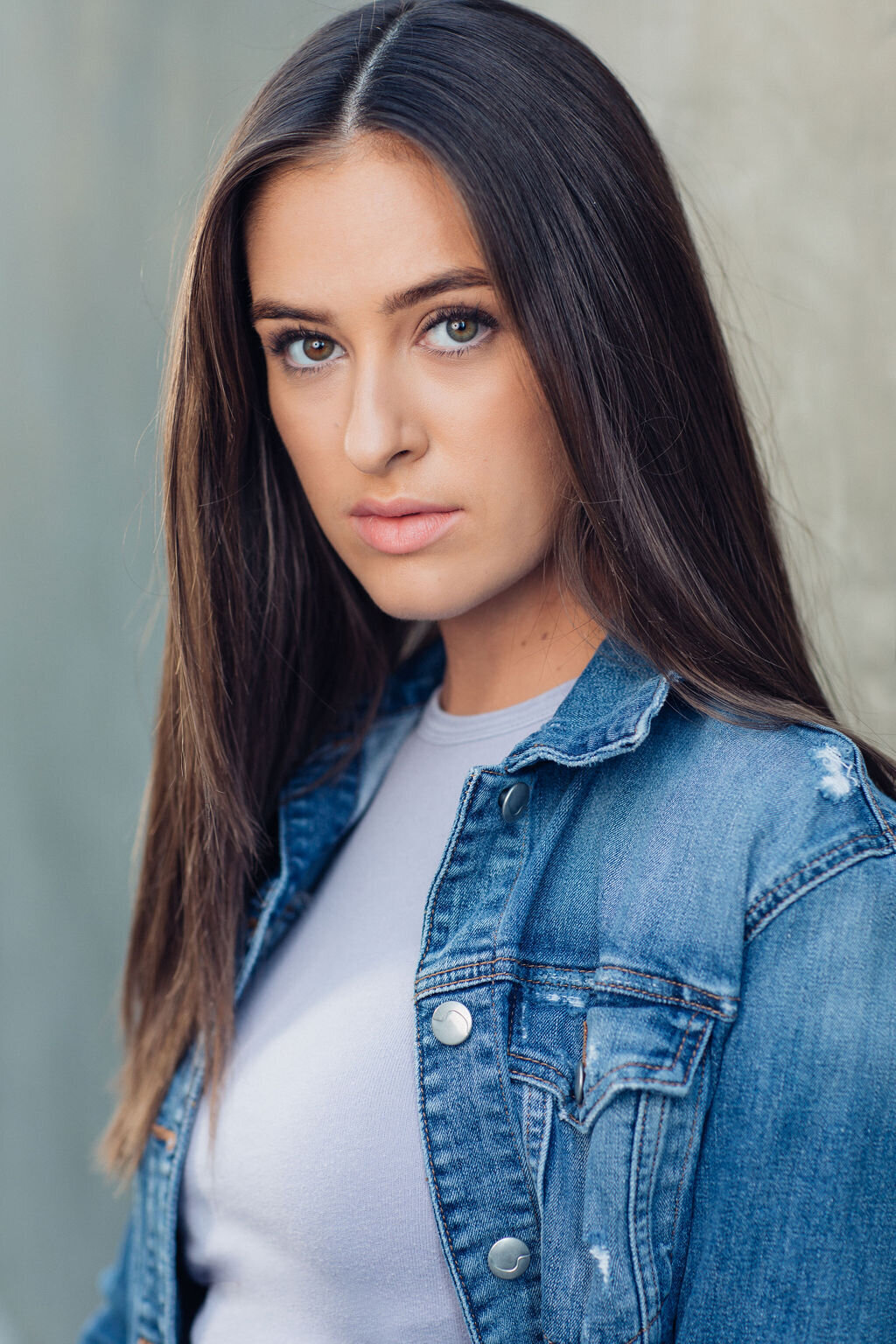 Headshot Photograph Of Young Woman In Blue Denim Jacket And Inner Lavender Shirt Los Angeles