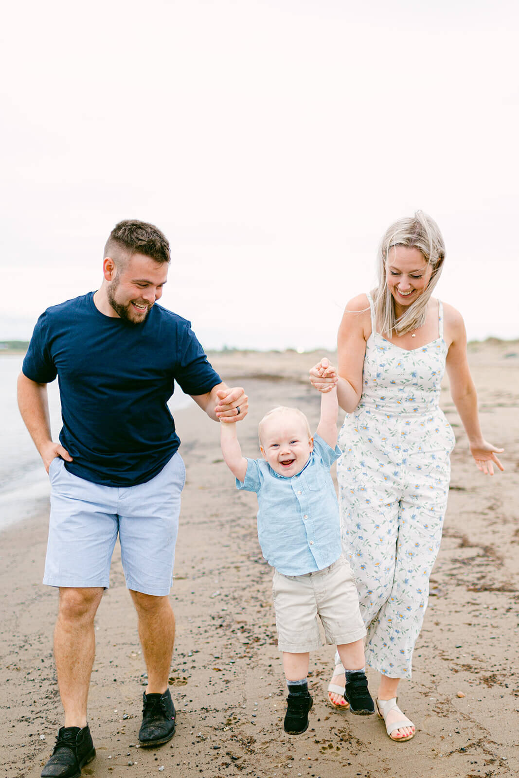 playful-family-with-kid-on-beach