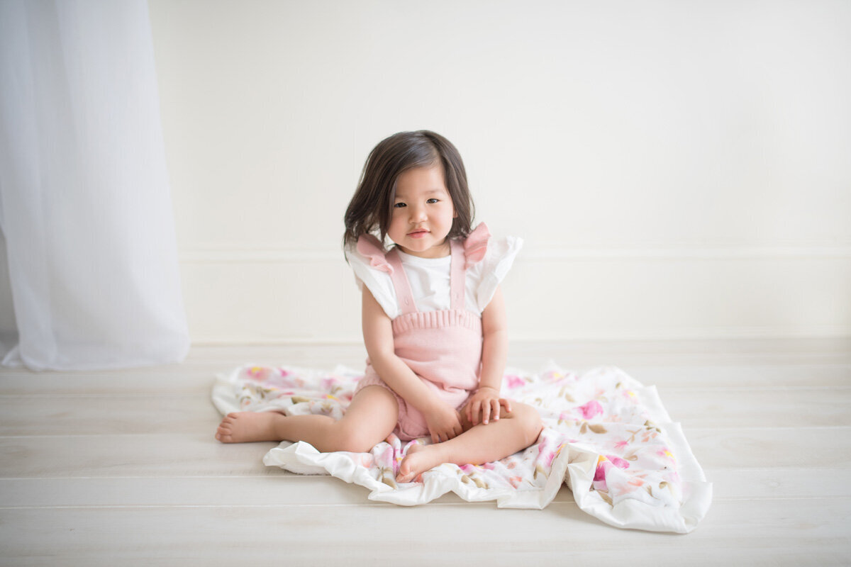 Family session with a little girl in a pink dress