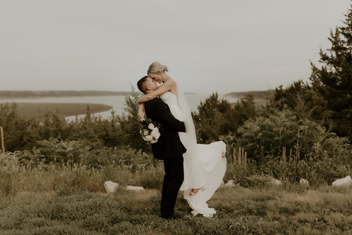 groom scooping bride up for a photo