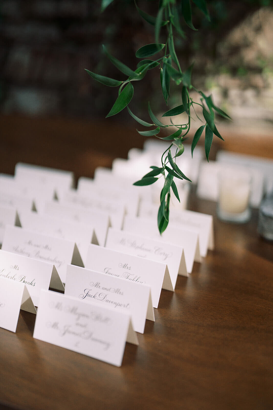 26.  Poeme place cards and cascading greenery decor.