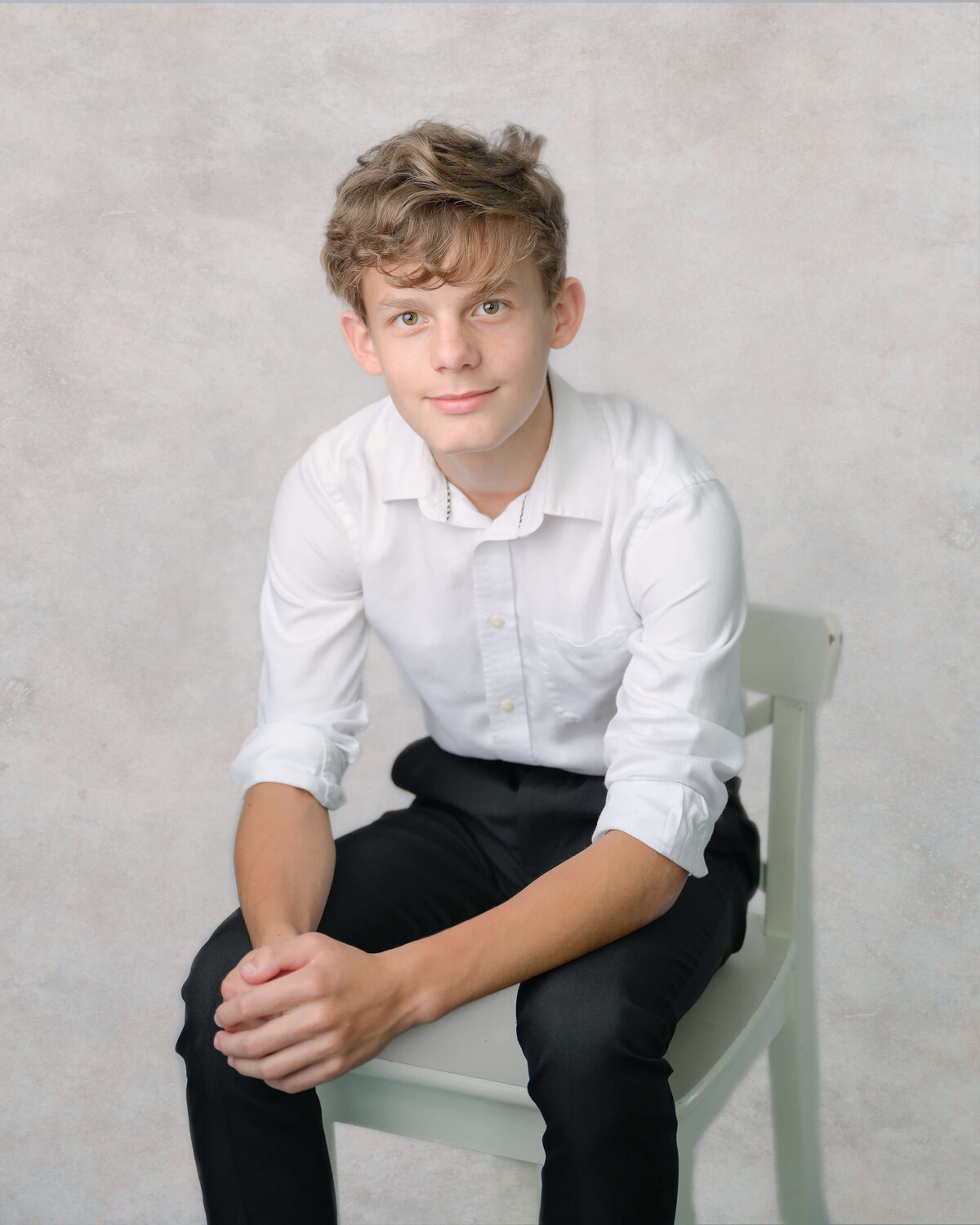 Dylan poses casually for this studio-like in home family photo session in McKinney, TX.