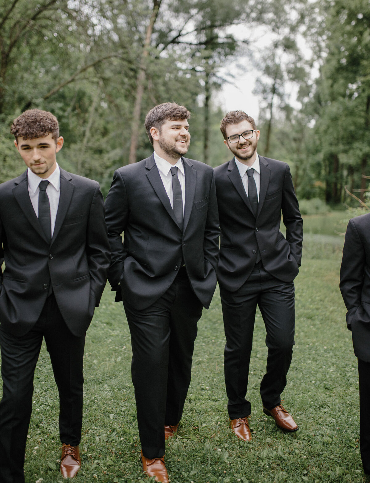 natural film wedding photographer in Michigan captures groomsmen laughing, candid wedding photographer in Michigan