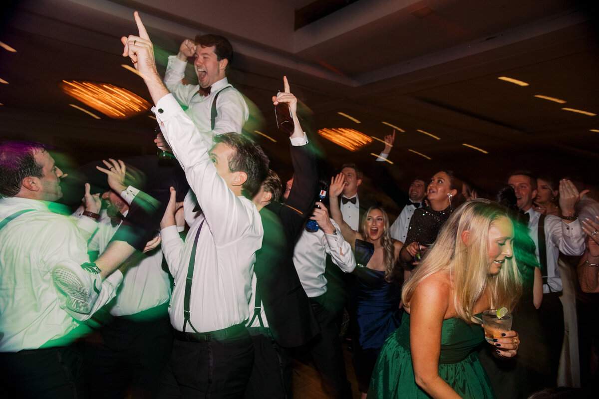 Groomsmen laughing at luxury wedding reception in Memphis, TN