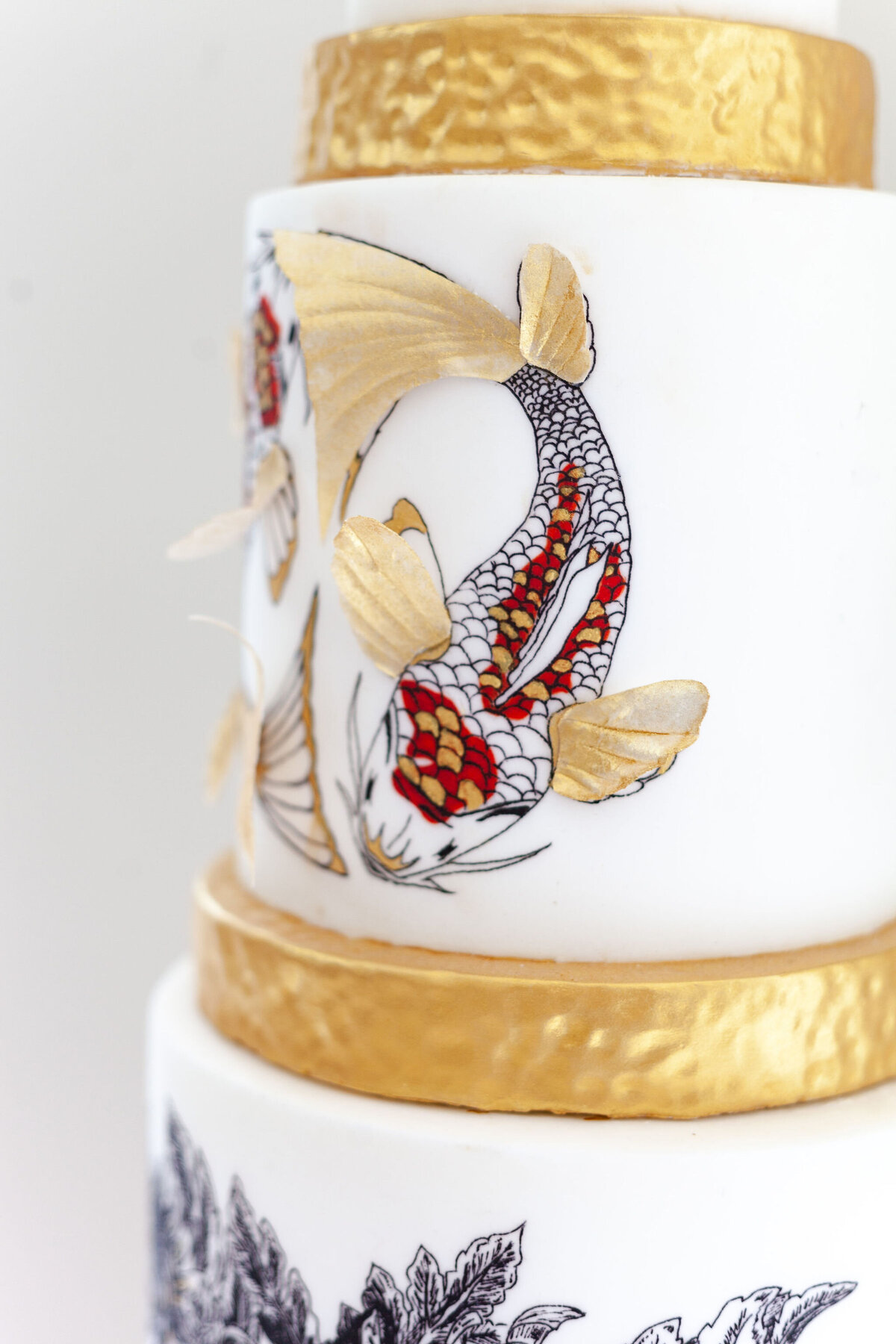 Luxury nature inspired wedding cake designer vanilla Spice Cake Studio Northamptonshire hand painted oriental koi carp gold leaf 3 tier design