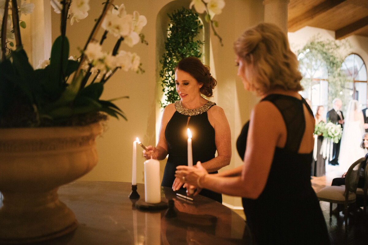 Photo of a two people lighting candles