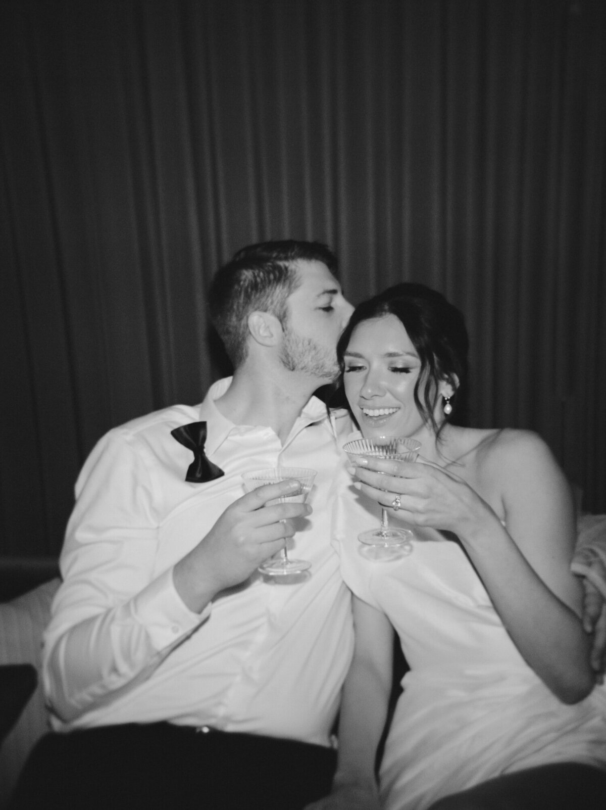 candid film wedding photo, couple sip champagne at Shinola Hotel