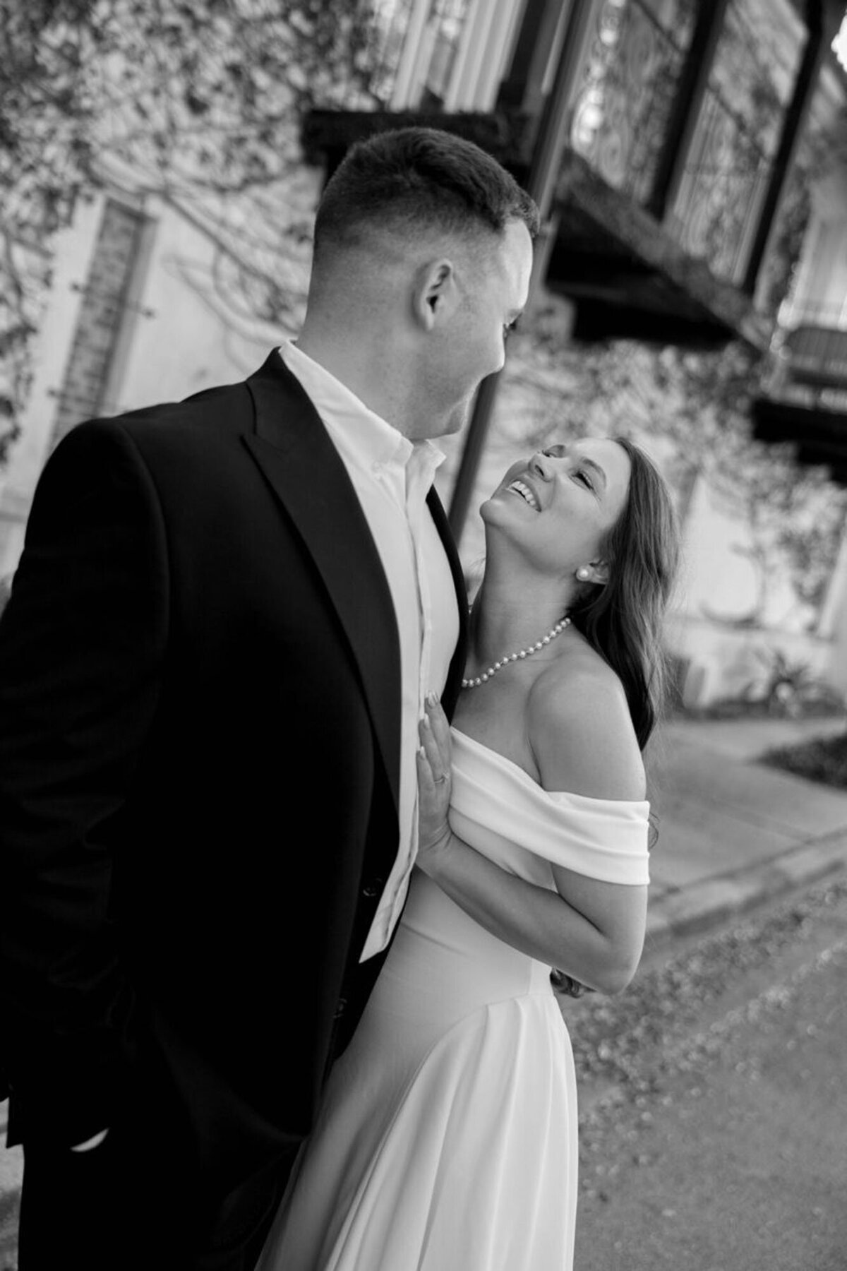 orlando engagement photography with the couple looking at each other in the city